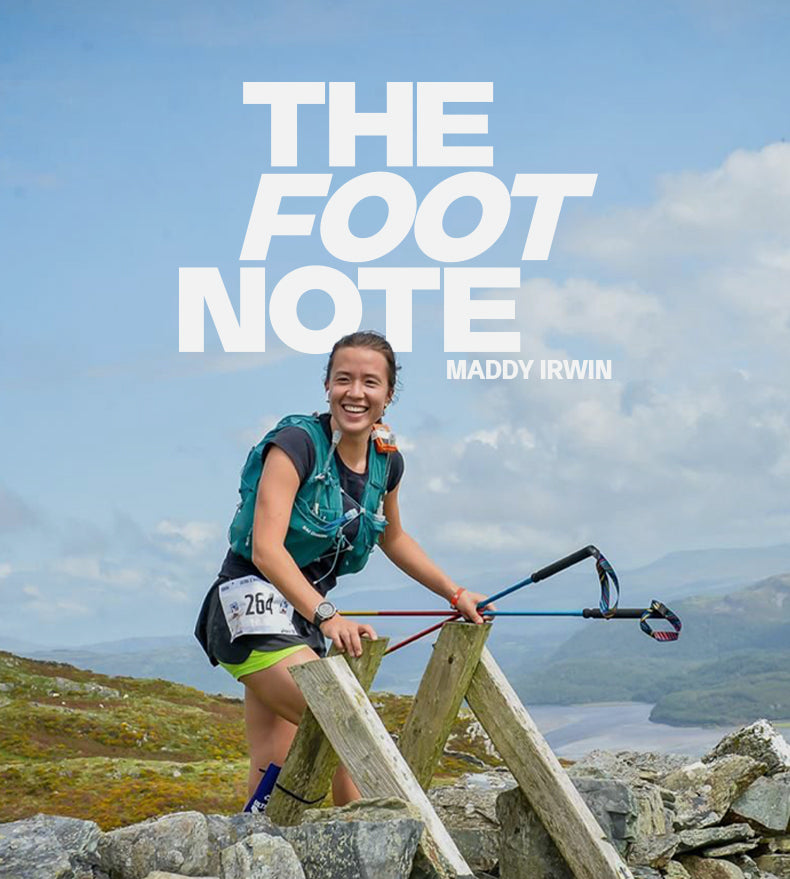  Photo of endurance athlete Maddy Irwin as she crosses a wall on the hillside landscape during an event.